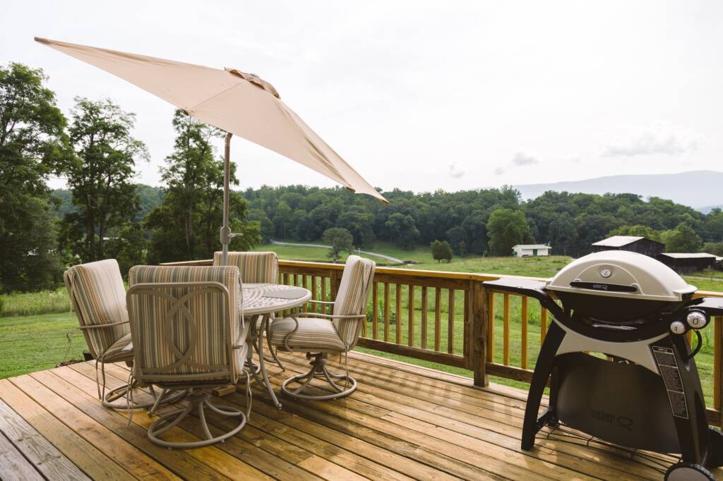 Backyard deck with grill and picnic table.