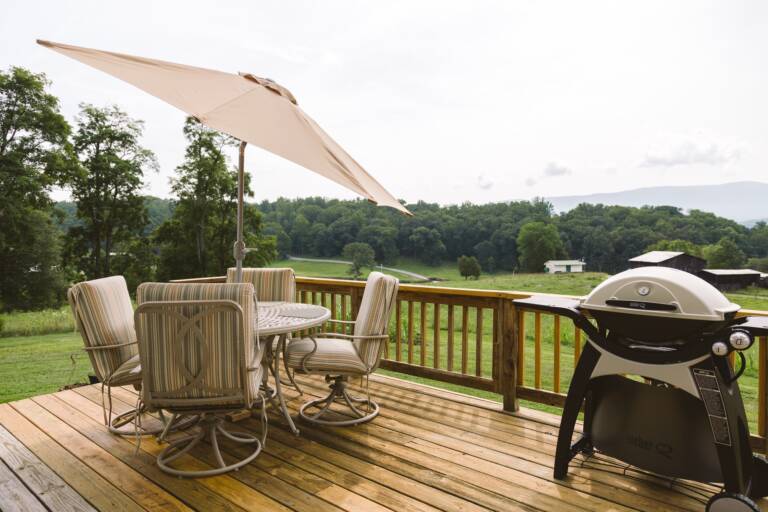 Backyard deck with grill and picnic table.