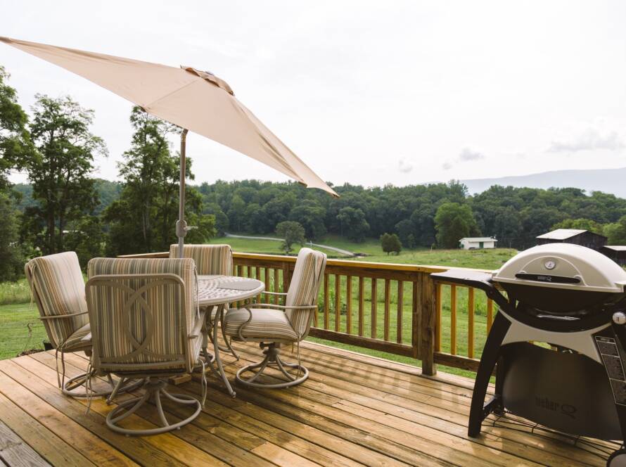Backyard deck with grill and picnic table.