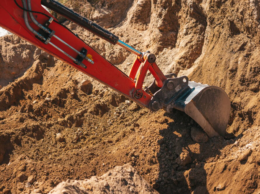 Excavator shovel digging on dirt